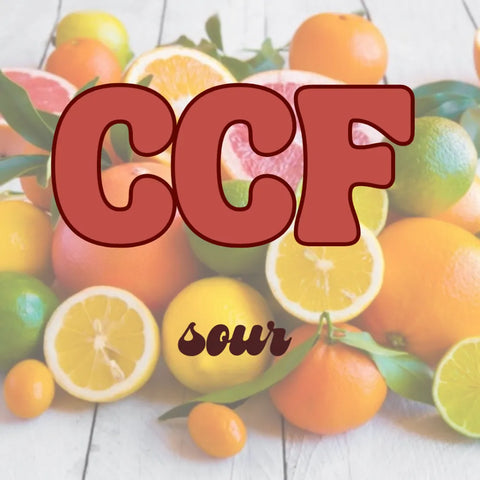Assorted citrus fruits with 'CCF sour' text overlay on a wooden surface.