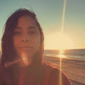 Woman with sunset and ocean in the background