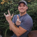 Man making a hand gesture with his fingers outdoors