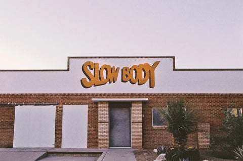Building with 'SLOW BODY' sign on the facade