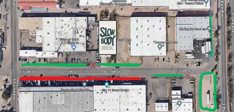 Aerial view of a street with buildings and a sign for 'Slow Body' restaurant.